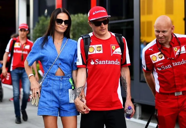Kimi Raikkonen of Finland and Ferrari and his girlfriend Minttu Virtanen walk in the paddock after qualifying for the Formula One Grand Prix of Hungary at Hungaroring on July 25, 2015 in Budapest, Hungary. (Photo by Lars Baron/Getty Images)