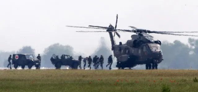 German armed forces Bundeswehr soldiers perform a rescue and evacuation operation for civilians next to a NH 90 helicopter at the ILA Berlin Air Show in Schoenefeld, south of Berlin, Germany, May 31, 2016. (Photo by Fabrizio Bensch/Reuters)