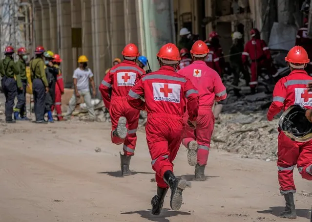Rescuers advance to help recover a body at the site of Friday's deadly explosion that destroyed the five-star Hotel Saratoga, in Havana, Cuba, Saturday, May 7, 2022. (Photo by Ramon Espinosa/AP Photo)