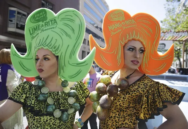 LeMay, left, dressed as Lime A Rita and Darcy Drollinger, right, dressed as Mang O Rita, wait by their float for the start of the 44th annual San Francisco Gay Pride parade Sunday, June 29, 2014, in San Francisco. The lesbian, gay, bisexual, and transgender celebration and parade is one of the largest LGBT gatherings in the nation. (Photo by Eric Risberg/AP Photo)