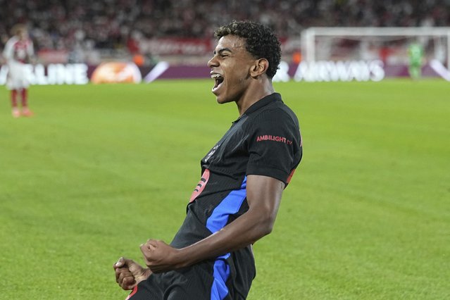 Barcelona's Lamine Yamal celebrates after scoring his side's opening goal during the Champions League opening phase soccer match between Monaco and Barcelona at the Louis II stadium, in Monaco, Monaco, Thursday, September 19, 2024. (Photo by Laurent Cipriani/AP Photo)