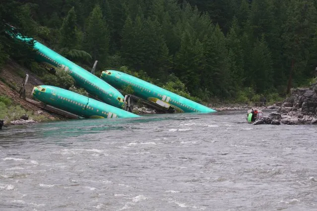Three Boeing 737 fuselages lie on an embankment on the Clark Fork River after a BNSF Railway Co train derailed Thursday near Rivulet, Montana in this picture taken July 4, 2014. A train derailment in Montana this week damaged a shipment of jetliner fuselages and other large parts on its way to Boeing Co factories in Washington state from Spirit Aerosystems, Boeing said on Saturday. (Photo by Kyle Massick/Reuters)