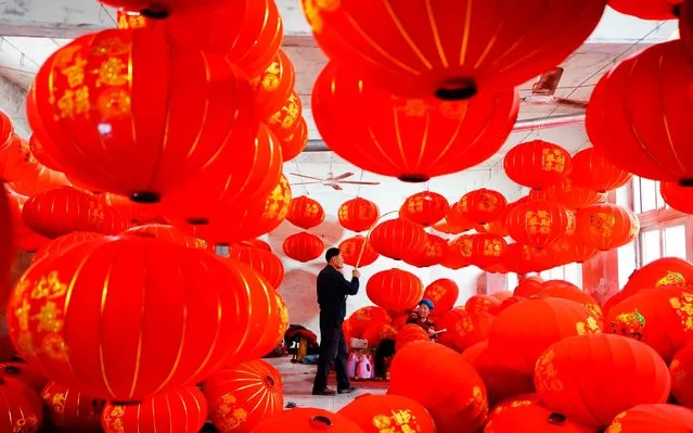 Villagers make and arrange red lanterns in Tuntou Village of Gaocheng District in Shijiazhuang City, north China's Hebei Province, January 7, 2020. As the Spring Festival approaches, lantern manufacturers in Gaocheng, which is known for its lantern production, are busy making red lanterns. (Photo by Xing Guangli/Xinhua News Agency)