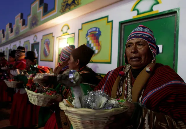 Aymara witch doctors hold offerings before a ceremony in El Alto near La Paz, Bolivia, June 21, 2016. (Photo by David Mercado/Reuters)