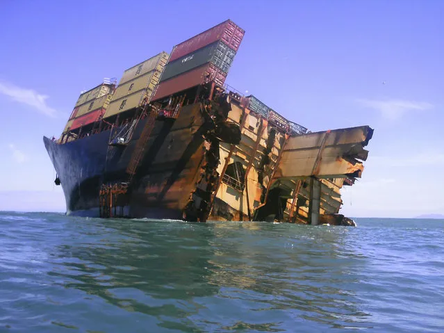 The bow section of the stricken container ship Rena remains above water after the stern broke off and sank about 14 nautical miles (Photo by 22 km) from Tauranga on the east coast of New Zealand’s North Island