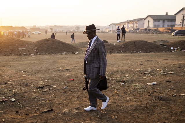 A man walks to a polling station during the presidential and legislative elections in Mbare, Harare on August 23, 2023. Zimbabweans on August 23, 2023 began voting in closely-watched presidential and legislative elections. (Photo by John Wessels/AFP Photo)