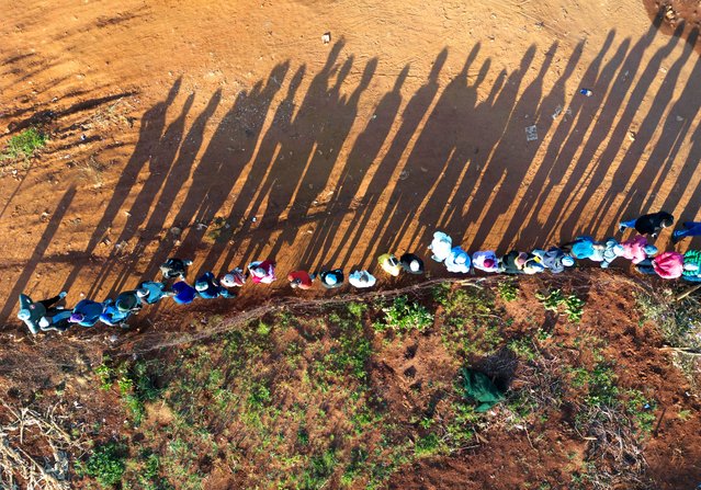 A drone view shows people queue at the Hospital Hills township to vote during the South African elections, in Johannesburg, South Africa on May 29, 2024. (Photo by Ihsaan Haffejee/Reuters)