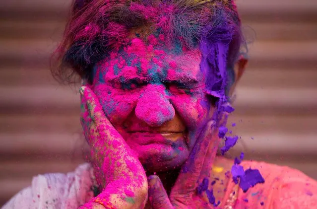 A woman reacts as coloured powder is applied to her face during Holi celebrations in Chennai, India, March 10, 2020. (Photo by P. Ravikumar/Reuters)
