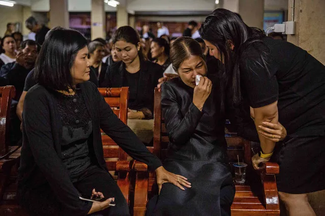 People comfort the mother of Ratchanon Karnchanamethee, a 13 year old boy, who was killed during a mass shooting at Terminal 21 Mall during his funeral on February 10, 2020 in Korat, Thailand.  On Saturday February 8 at Terminal 21 Mall in Korat Nakhon Rachasima, three hours from Bangkok, Sgt. Maj. Jakrapanth Thomma opened fire and killed at least 26 people and wounded 57 others in a 16 hour rampage before being shot down by Thai Police. (Photo by Lauren DeCicca/Getty Images)