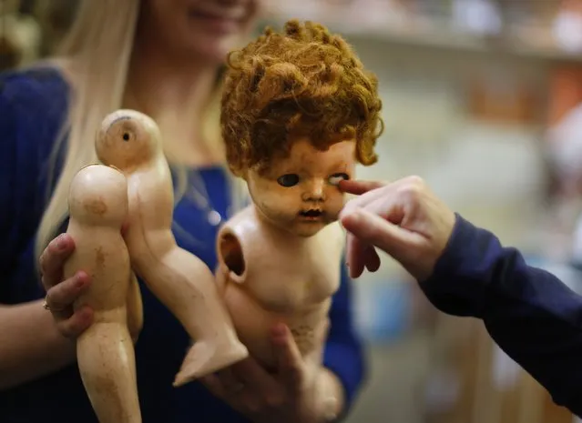 A damaged doll is brought in for repair by a customer at Sydney's Doll Hospital, May 20, 2014. (Photo by Jason Reed/Reuters)