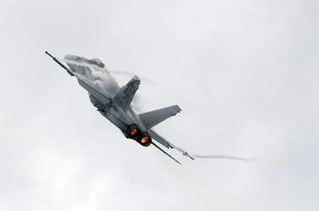 A Swiss Air Force F/A 18 Hornet aircraft performs during the Air14 airshow at the airport in Payerne August 31, 2014. The Swiss Air Force celebrates their 100th anniversary with the biggest airshow in Europe this year. (Photo by Denis Balibouse/Reuters)