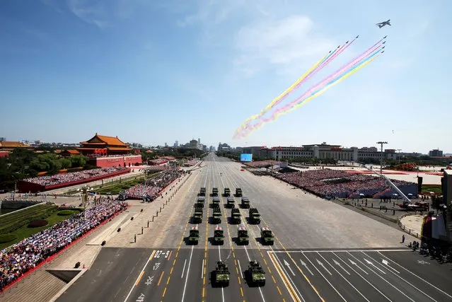 People's Liberation Army (PLA) aircraft and vehicles drive in formation past the Tiananmen Gate during a military parade marking the 70th anniversary of the end of World War Two, in Beijing, China, September 3, 2015. (Photo by Yao Dawei/Reuters/Xinhua)