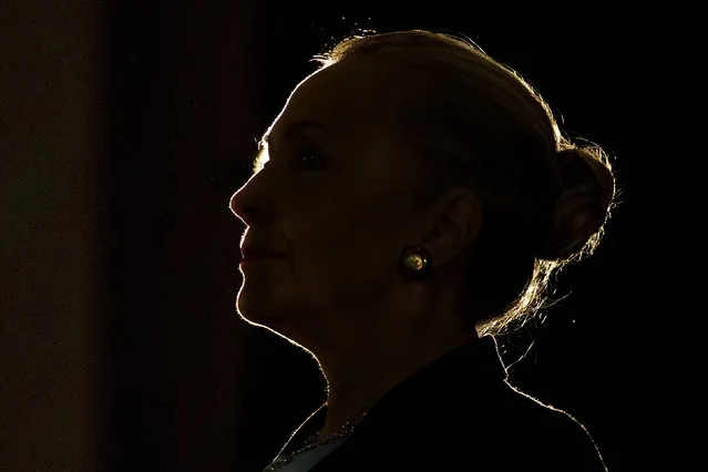 Silhouetted by a stage light, Secretary of State Hillary Rodham Clinton speaks at the University of the Western Cape about U.S.-South Africa partnership, Wednesday, August 8, 2012, in Cape Town, South Africa. (Photo by Jacquelyn Martin/AP Photo)