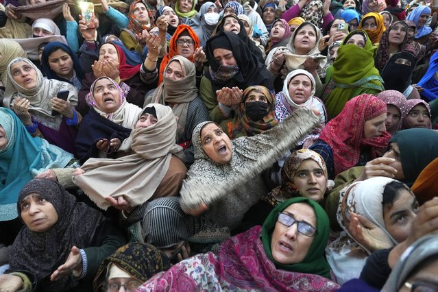 Kashmiri Muslim devotees pray as a head priest displays a relic, believed to be a hair from the beard of the Prophet Muhammad, at the Hazratbal shrine on Mehraj-u-Alam,  believed to mark the ascension of Prophet Muhammad to heaven, in Srinagar, Indian controlled Kashmir, Tuesday, January 28, 2025. (Photo by Mukhtar Khan/AP Photo)