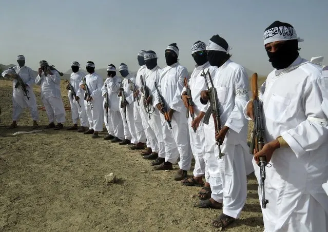 In this Monday, August 15, 2016 photo, Taliban suicide bombers stand guard during a gathering of a breakaway Taliban faction, in the border area of Zabul province, Afghanistan. The faction appointed a new leader for the group, the nephew of the faction's leader who was killed last year. The development was announced in a video that was made available to The Associated Press. It said that Mullah Emdadullah Mansoor was named leader of the faction known as Mahaaz-e-Dadullah at a gathering on Monday in southern Zabul province. The meeting was attended by tribal and religious leaders, as well as the group's local commanders. (Photo by Mirwais Khan/AP Photo)