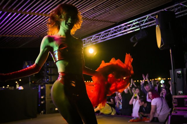 Rayne O'Plasty dances at Pride Park, a venue for artistic shows ahead the Pride 2021 in Bucharest, Romania, Thursday, August 12, 2021. (Photo by Vadim Ghirda/AP Photo)