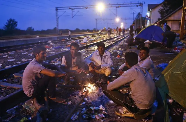 Migrants sit on railway tracks at a train station in Tovarnik, Croatia, September 20, 2015. (Photo by Antonio Bronic/Reuters)