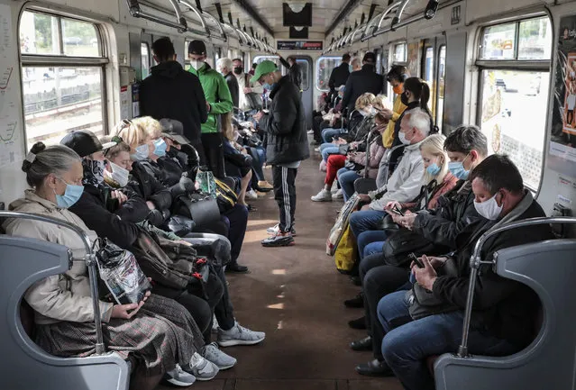 Commuters wear obligatory face masks on a train after the Kyiv Metro reopened on May 25 as part of the easing of the coronavirus lockdown in Kyiv, Ukraine on May 28, 2020. (Photo by Ukrinform/Rex Features/Shutterstock)