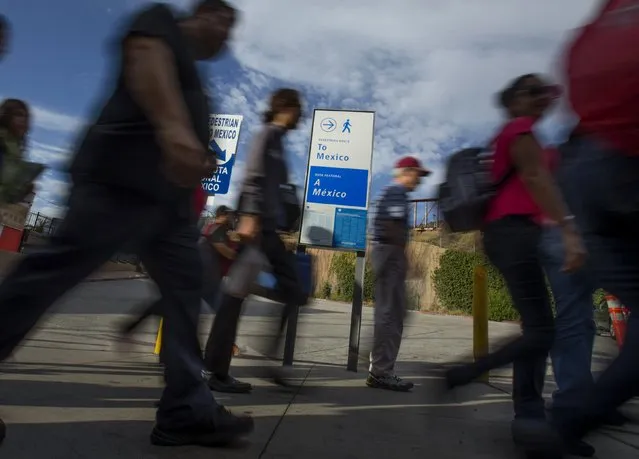 Pedestrians walk from a street car stop to the Mexican border pedestrian crossing in the border town of San Ysidro, California September 2, 2015. (Photo by Mike Blake/Reuters)