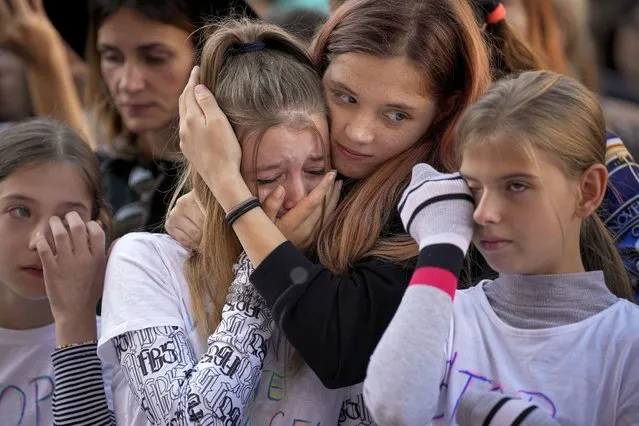 Participants cry while listening to a speech by a victim of domestic violence during a protest aiming to raise awareness to the violence and prejudice against women in Romanian society in Bucharest, Romania, Sunday, October 23, 2022. (Photo by Andreea Alexandru/AP Photo)