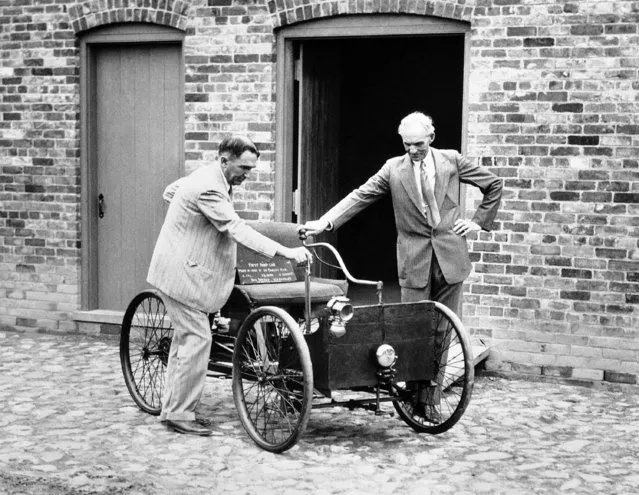 One of the most prized possessions of Henry Ford is his first automobile. It was built in 1892 in the brick barn before which Mr. Ford stands with James Bishop in Detroit, Michigan on December 6, 1936. (Photo by AP Photo)
