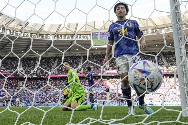 Japan's goalkeeper Shuichi Gonda and Yuki Soma look at the ball getting into the net for Costa Rica's Keysher Fuller to score his side's opening goal, during the World Cup, group E soccer match between Japan and Costa Rica, at the Ahmad Bin Ali Stadium in Al Rayyan , Qatar, Sunday, November 27, 2022. (Photo by Darko Bandic/AP Photo)