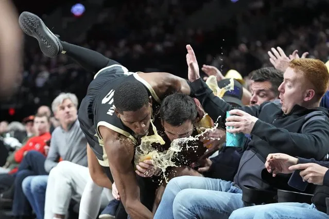 Purdue guard Brandon Newman (5) falls into the seating area during the first half of the team's NCAA college basketball game against Gonzaga in the Phil Knight Legacy tournament Friday, November 25, 2022, in Portland, Ore. (Photo by Rick Bowmer/AP Photo)