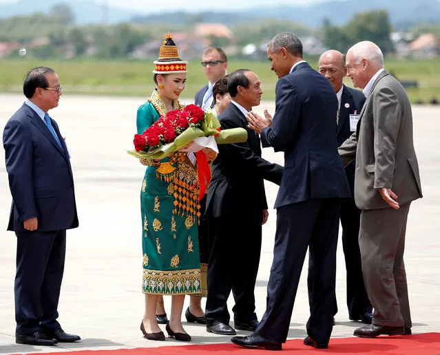 U.S. President Barack Obama is greeted with flowers as he arrives at Luang Prabang airport for a cultural visit alongside his participation in the ASEAN Summit, in Luang Prabang, Laos, September 7, 2016. (Photo by Jonathan Ernst/Reuters)