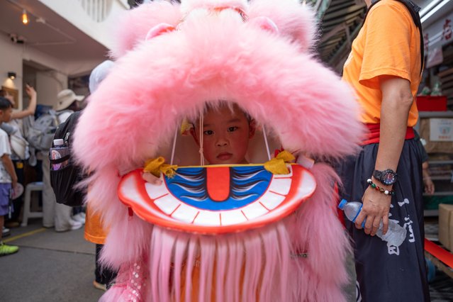 A boy performs a lion dance at the Piu Sik Parade during celebrations of the Bun Festival at Cheung Chau island in Hong Kong, China, 05 May 2025. The Cheung Chau Bun Festival, recognised as part of China's national list of intangible cultural heritage, is an annual festival that celebrates the end of a plague that struck the island of Cheung Chau during the Qing dynasty, with bun-scrambling competition and Piu Sik Parade as the most significant activities in the festival. (Photo by Bertha Wang/EPA/EFE)