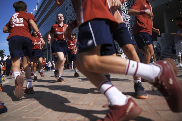 Ball boys and girls warm up for the French Tennis Open at the Roland-Garros stadium in Paris, Tuesday, June 3, 2025. (Photo by Christophe Ena/AP Photo)