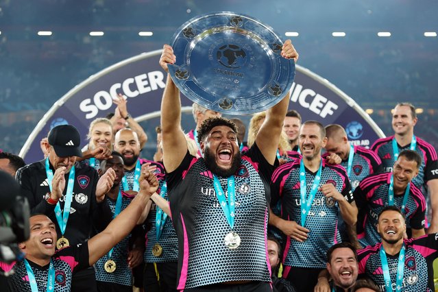 Big Zuu of World XI lifts the Soccer Aid 2025 trophy with teammates during Soccer Aid 2025 at Old Trafford on June 15, 2025 in Manchester, England. (Photo by Matt McNulty/Getty Images)