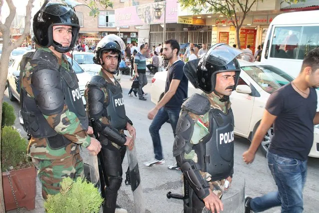 Riot policemen stand guard during a patrol looking for anti-government rioters in the streets of Sulaimaniya, northern Iraq October 13, 2015. The prime minister of Iraqi Kurdistan removed four ministers from his cabinet on Monday and the speaker of parliament was barred from entering the capital in an escalating political crisis that threatens to destabilise the region. (Photo by Reuters/Stringer)