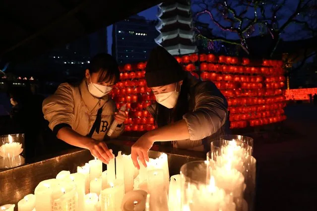 South Koreans light candles at Jogye temple during the New Year Eve on December 31, 2022 in Seoul, South Korea. South Koreans will celebrate in central Seoul after the New Year event was held without an audience for the past three years due to the COVID-19 pandemic. (Photo by Chung Sung-Jun/Getty Images)