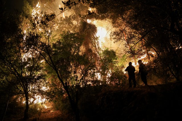 Firefighters try to tackle a wildfire burning on Chios island, Greece, on June 23, 2025. (Photo by Konstantinos Anagnostou/Reuters)