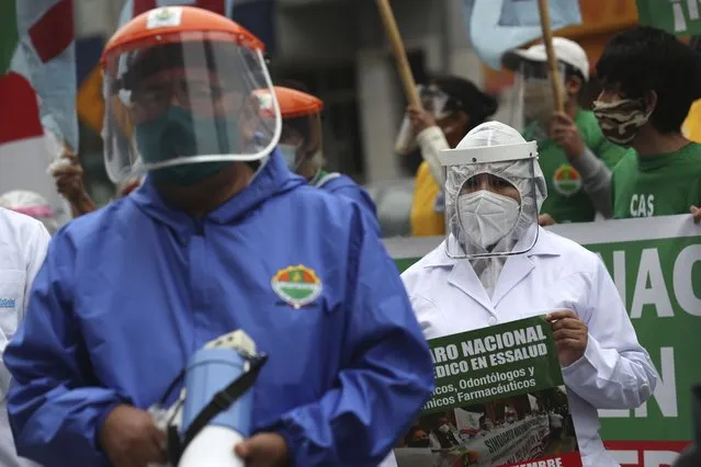 Health workers protest against the lack of protective equipment for those attending COVID-19 patients, outside a public hospital in Lima, Peru, Tuesday, September 29, 2020. (Photo by Martin Mejia/AP Photo)