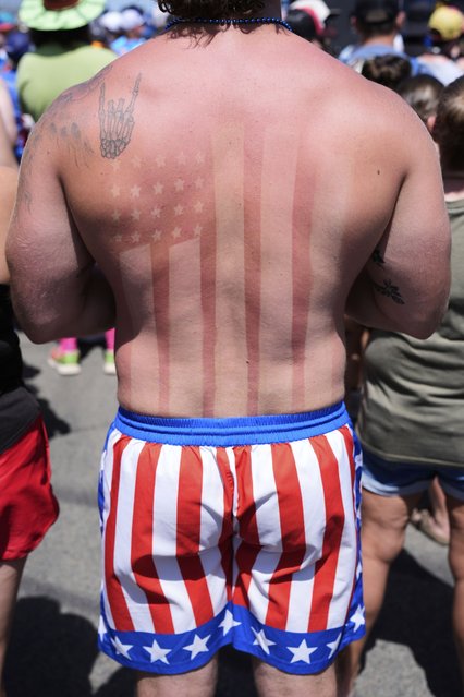 Noah Mack displays American flags on his shorts and in his sunburn before the start of a NASCAR Cup Series auto race in Watkins Glen, N.Y., Sunday, August 10, 2025. (Photo by Seth Wenig/AP Photo)