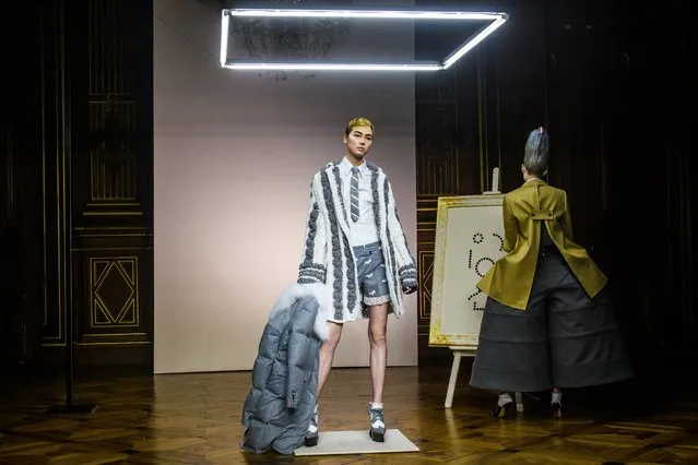 A model presents a creation before the Fall/ Winter 2018/2019 show of the Women Ready to Wear collection by US designer Thom Browne during the Paris Fashion Week, in Paris, France, 04 March 2018. The presentation of the Women's collections runs from 26 February to 06 March 2018. (Photo by Christophe Petit Tesson/EPA/EFE)