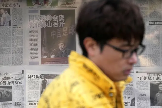 A man walks past a kiosk displaying a newspaper with a photo of Chen Xuyuan, head of the Chinese Football Association, in Beijing, Wednesday, February 15, 2023. The head of China's national soccer federation has been arrested on corruption charges in the latest blow to the country's effort to grow its standing at home and internationally. (Photo by Andy Wong/AP Photo)