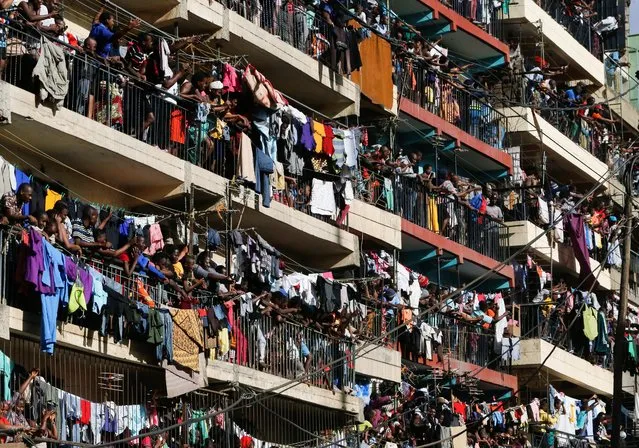Residents watch from their balconies as Kenya's opposition leader Raila Odinga of the Azimio La Umoja (Declaration of Unity) One Kenya Alliance, and his supporters participate in a nationwide protest over cost of living and President William Ruto's government in Mathare settlement of Nairobi, Kenya on March 20, 2023. (Photo by Thomas Mukoya/Reuters)