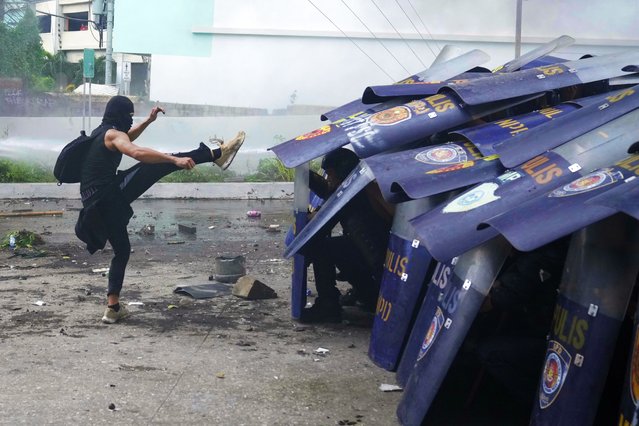 An anti-corruption protester kicks the shield of a policeman during clashes in Manila, Philippines on Sunday, September 21, 2025. (Photo by Aaron Favila/AP Photo)