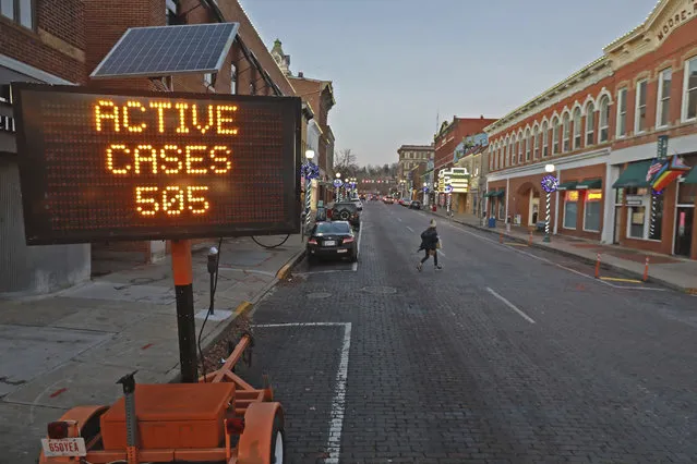 In this December 2, 2020, file photo, a flashing sign on Court Street in Athens, Ohio, reports the number of active COVID-19 cases in the community. States faced a deadline on Friday, Dec. 4, 2020, to place orders for the coronavirus vaccine as many reported record infections, hospitalizations and deaths, while hospitals were pushed to the breaking point – with the worst feared yet to come. (Photo by Doral Chenoweth/The Columbus Dispatch via AP Photo/File)