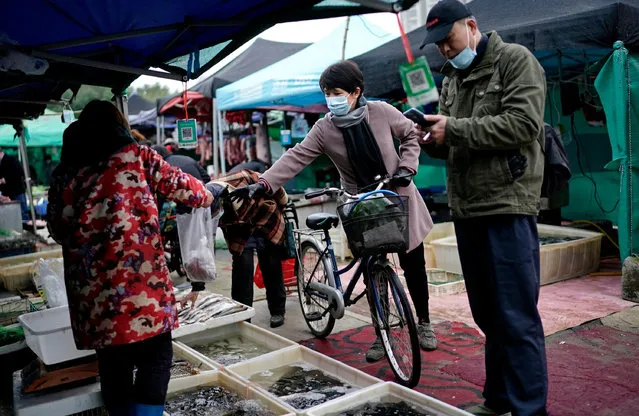 Vendors selling fish in an open market on December 2, 2020 in Wuhan, Hubei province,China. With no recorded cases of community transmissions since May, life for residents is gradually returning to normal. (Photo by Getty Images)