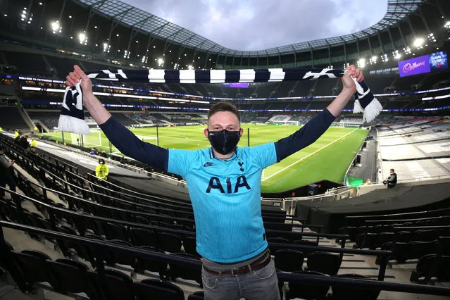 A Tottemham Hotspur fan wearing a protective face mask poses for a photograph inside the stadium ahead of the Premier League match between Tottenham Hotspur and Arsenal at Tottenham Hotspur Stadium on December 06, 2020 in London, England. A limited number of fans (2000) are welcomed back to stadiums to watch elite football across England. This was following easing of restrictions on spectators in tiers one and two areas only. (Photo by Tottenham Hotspur FC/Tottenham Hotspur FC via Getty Images)