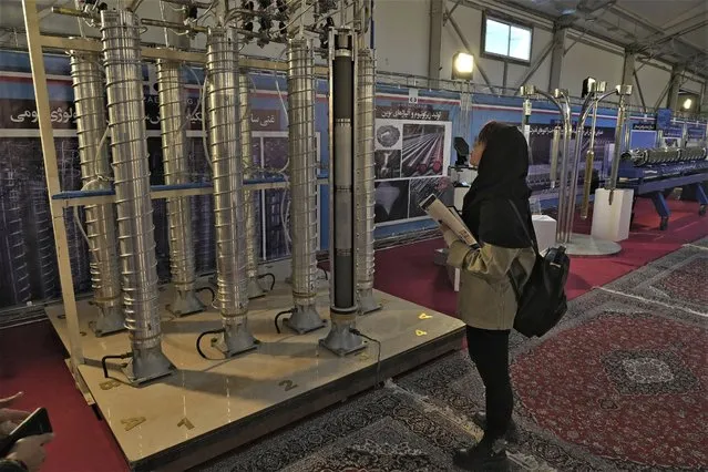 A student looks at Iran's domestically built centrifuges in an exhibition of the country's nuclear achievements, in Tehran, Iran, Wednesday, February 8, 2023. The head of the United Nations nuclear watchdog on Tuesday underscored the urgency of resuscitating diplomatic efforts to limit Iran's nuclear program, saying the situation could quickly worsen if negotiations fail. (Photo by Vahid Salemi/AP Photo)