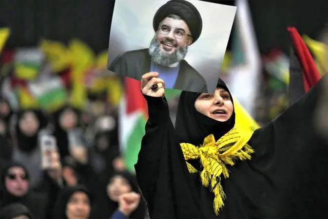 A woman shouts slogans, as she holds a portrait for Hezbollah leader Sayyed Hassan Nasrallah during a rally to mark Jerusalem day, in a southern suburb of Beirut, Lebanon, Friday, April 14, 2023. Since Iran's Islamic Revolution in 1979, the rallies marking what is also known as al-Quds Day have typically been held on the last Friday of the Muslim holy month of Ramadan. (Photo by Hussein Malla/AP Photo)