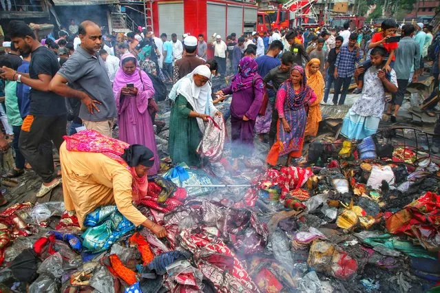 Fire-victim traders search for their merchandises, money and other valuables while smoke kept emanating from the charred ruins on Wednesday after a fire razes down Bangabazar shopping complex that housed several thousand shops at Phulbariai n Dhaka on April 05 , 2023. (Photo by Sony Ramany/NurPhoto via Getty Images)