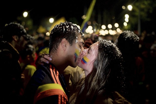Colombia fans kiss in celebration of their country's victory over Uruguay in a Copa America soccer semifinal, after watching a broadcast in Bogota, Colombia, Wednesday, July 10, 2024. (Photo by Ivan Valencia/AP Photo)
