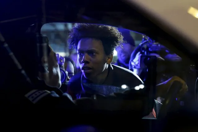 Protestors including Lamon Reccord, 16, confront police during a demonstration in response to the fatal shooting of Laquan McDonald in Chicago, Illinois, November 25, 2015. (Photo by Andrew Nelles/Reuters)
