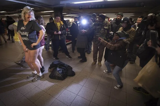 People take photos of participants taking part in the “No Pants Subway Ride” in the Manhattan borough of New York January 11, 2015. (Photo by Carlo Allegri/Reuters)