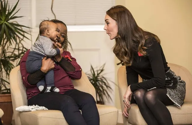 Catherine, Duchess of Cambridge makes faces at 4 month old Gabriel as she talks to his mother Hlengiwe Sithole during a visit to the Nelson trust women's centre in Gloucester, Britain November 4, 2016. (Photo by Richard Pohle/Reuters)